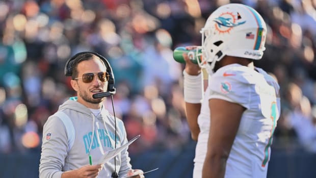 Nov 6, 2022; Chicago, Illinois, USA; Miami Dolphins head coach Mike McDaniel talks with quarterback Tua Tagovailoa (1) during the fourth quarter against the Chicago Bears at Soldier Field. Miami defeated Chicago 35-32.